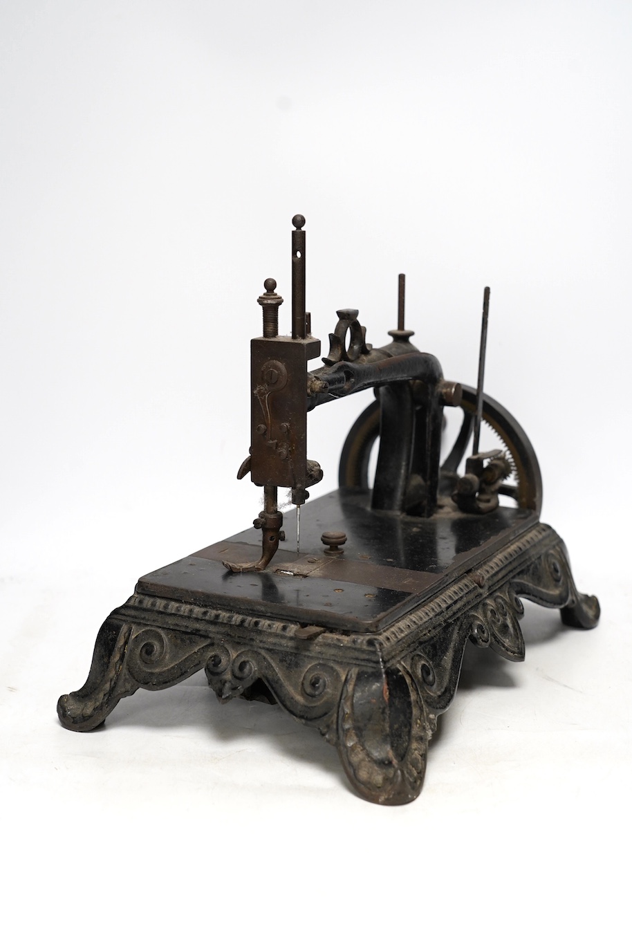 A late 19th century Atlas Brunonia sewing machine with decorative cast iron base. Condition - fair